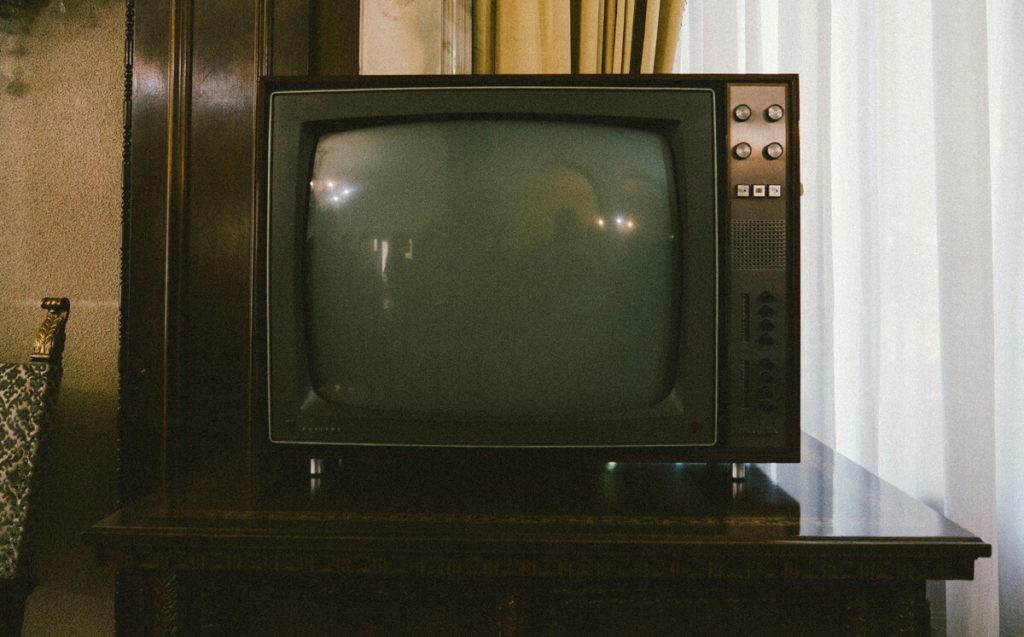 1970s-television-set-on-polished-wooden-table