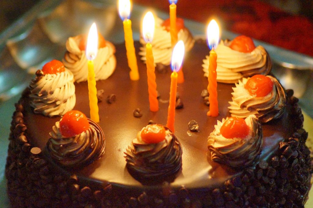 Black-forest-cake-with-lit-birthday-candles