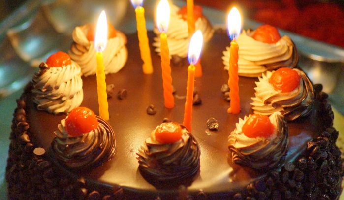 Black-forest-cake-with-lit-birthday-candles