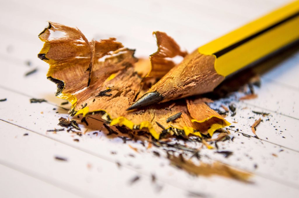 Tip-of-sharpened-yellow-pencil-laying-on-pencil-shavings