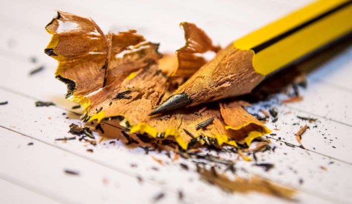 Tip-of-sharpened-yellow-pencil-laying-on-pencil-shavings