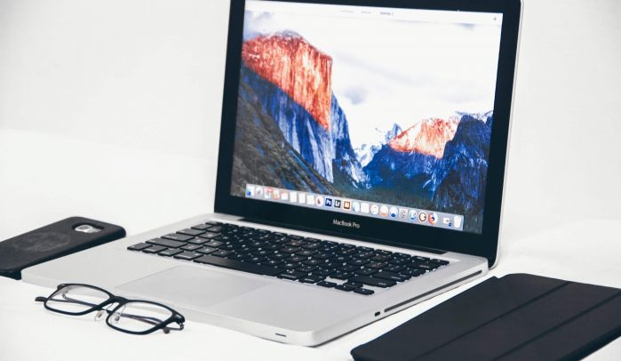Desktop-with-laptop-iPad-iPhone-and-glasses