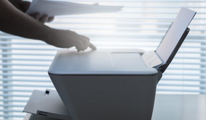 Hand-pressing-button-on-inkjet-printer