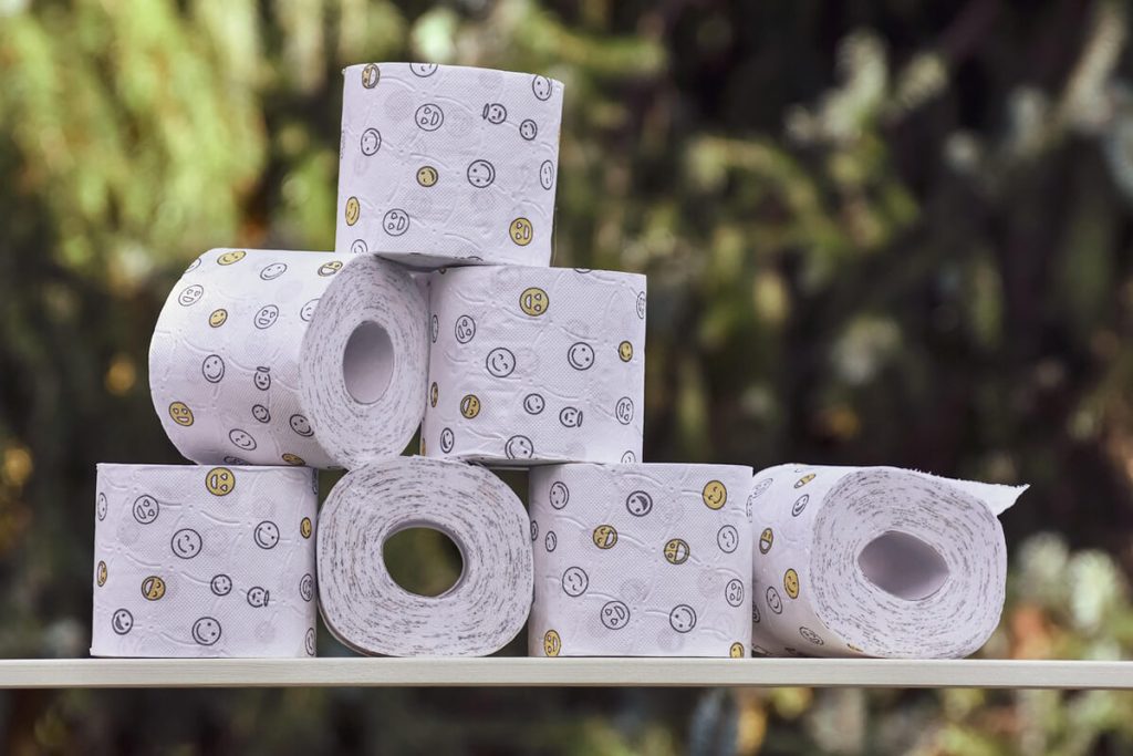 Stack-of-patterned-toilet-rolls-on-an-outside-table