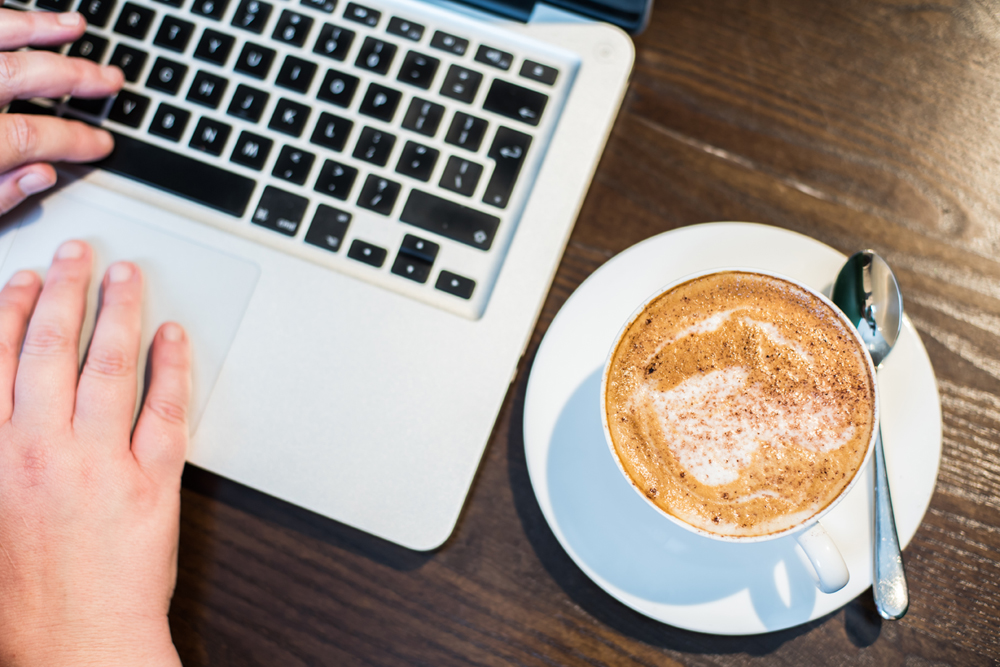 Laptop-keyboard-and-cappuccino-from-above