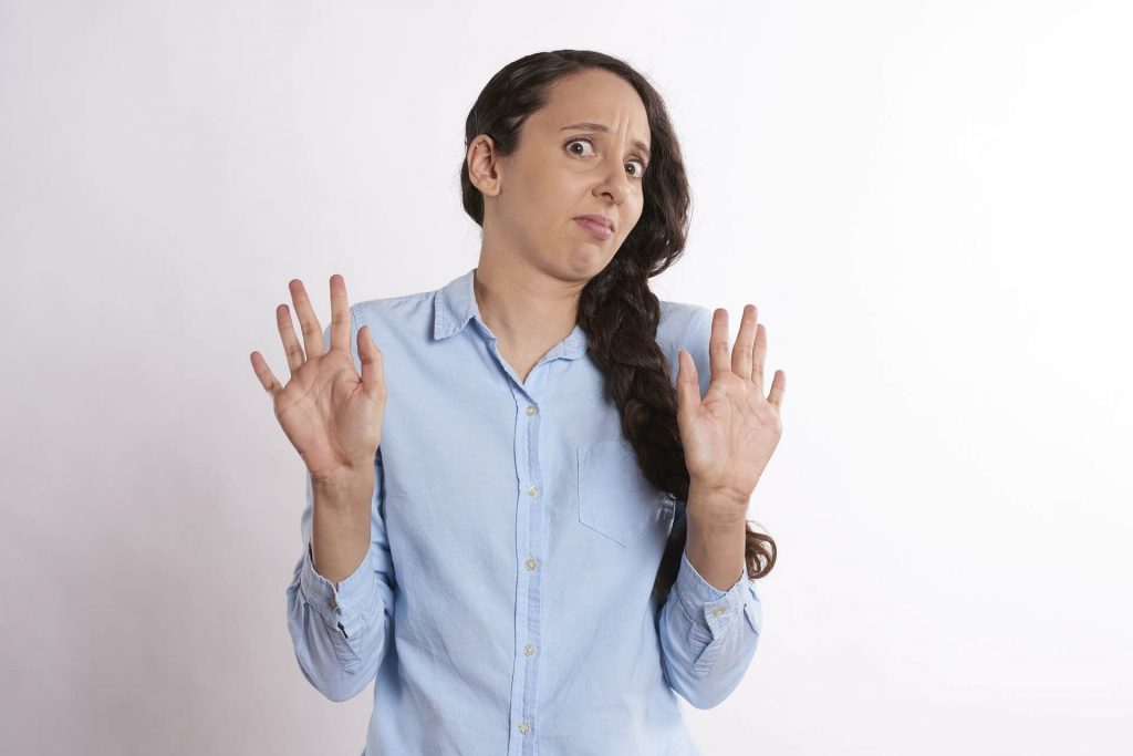 Woman-with-hands-up-looking-shocked