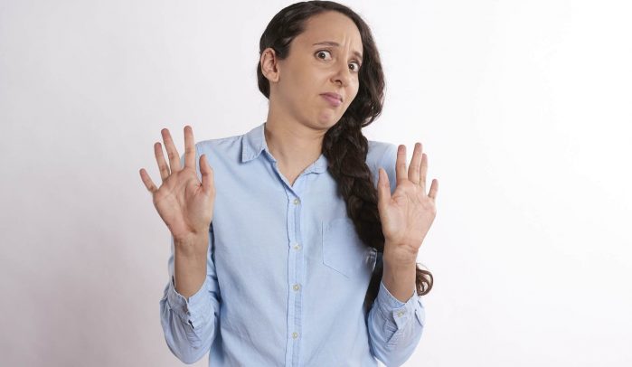 Woman-with-hands-up-looking-shocked