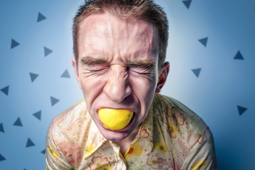 Pained-man-sucking-on-lemon