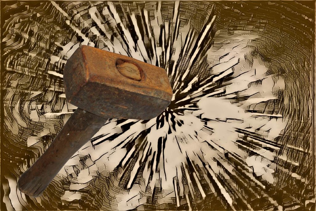 Wooden-hammer-smashing-through-surface