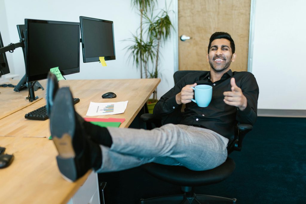 Happy-man-with-feet-up-on-office-desk