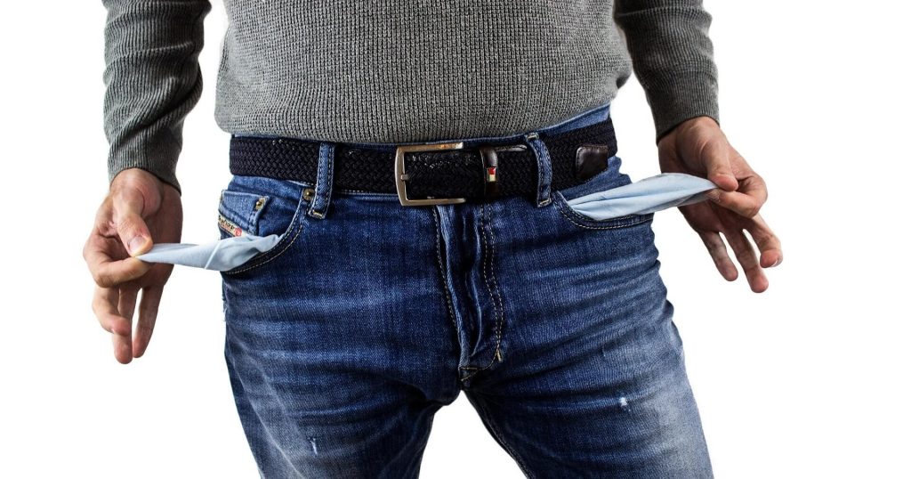 Man showing empty jeans pockets