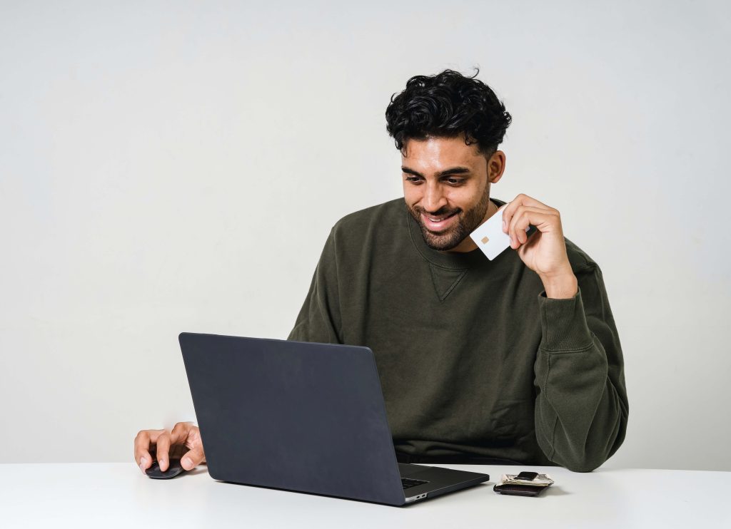 Man with credit card, about to purchase something online