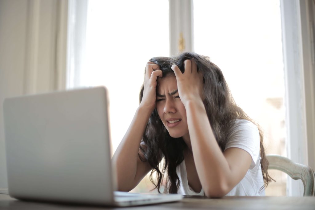 Woman looking confused at laptop