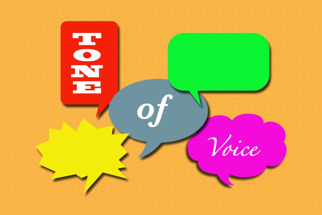 Speech bubbles in different colours and shapes containing the words 'Tone of Voice'