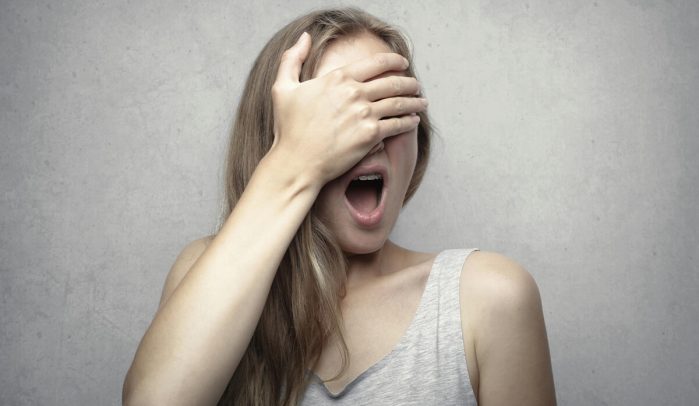 Woman-with-hand-over-her-eyes-in-shock