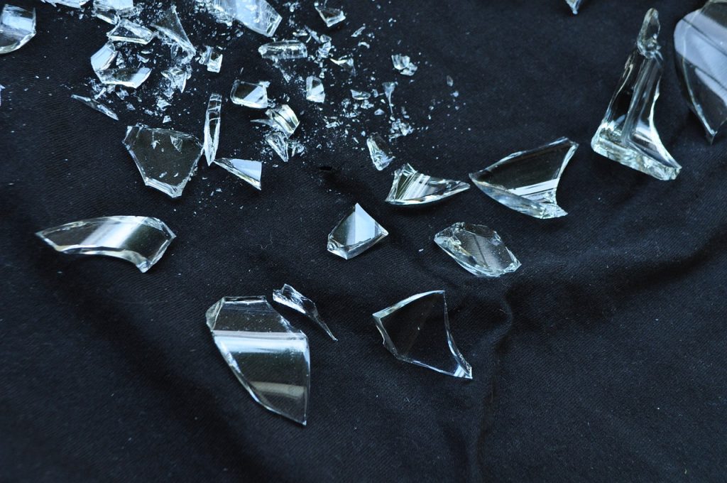 Broken-glass-on-dark-background-with-white- light-shining-on-it