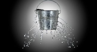 Metal-bucket-leaking-water